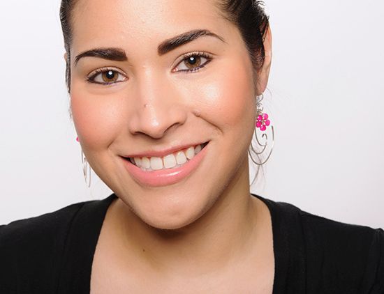 Woman wearing pink earrings with a white background