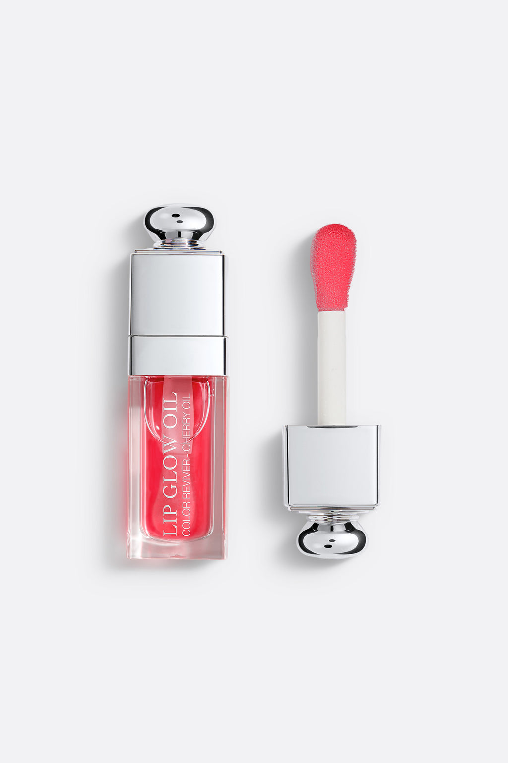 Lip gloss with applicator on a white background Addict Glow Oil