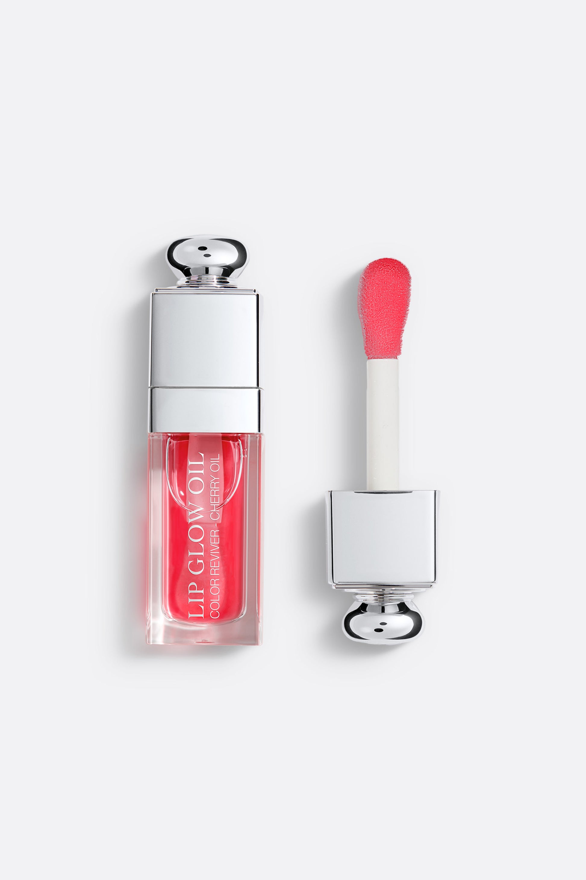 Lip gloss with applicator on a white background Addict Glow Oil