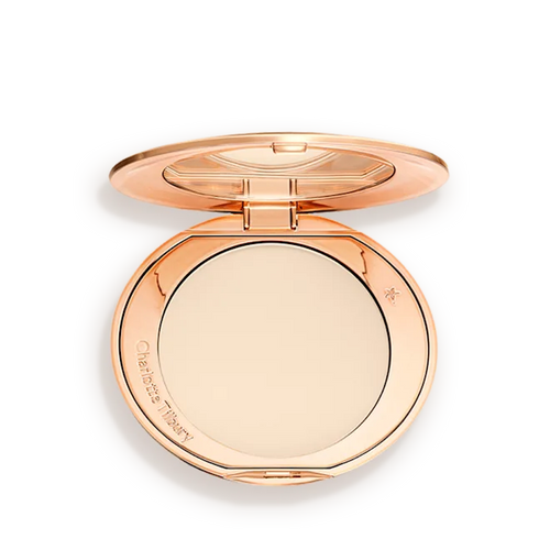 Rose gold compact powder case on a white background