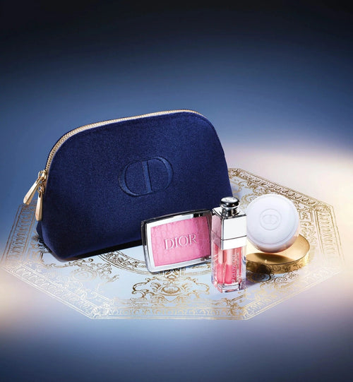 Dior cosmetic bag with makeup items on a decorative tray