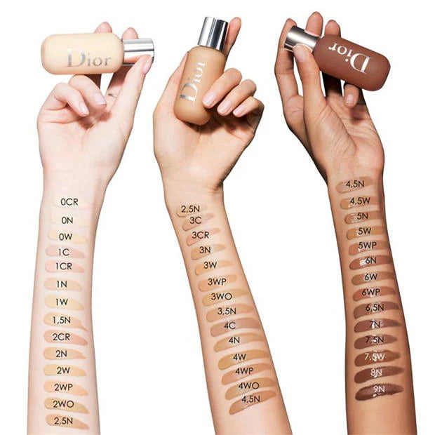 Dior foundation swatches tried on different skin tones on a white background