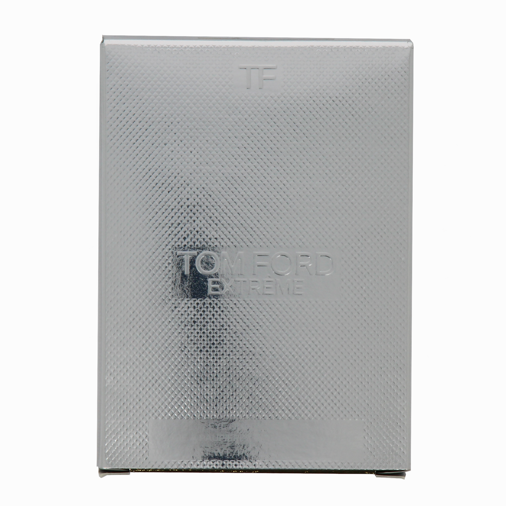 Silver textured box with 'Tom Ford Extreme' branding on a white background